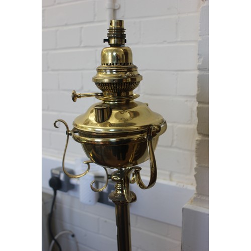 48 - A Victorian gilt brass floor lamp, now adapted for electricity, on tripod base, 135cm high, a slight... 