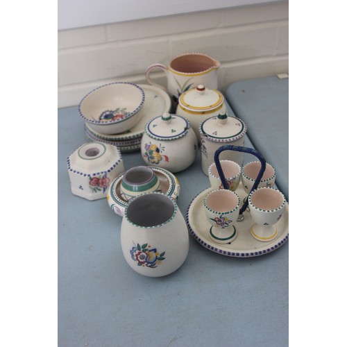 255 - A Poole pottery flower pattern egg cup stand and four egg cups, three preserve pots, three coasters,... 