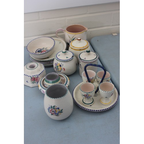 255 - A Poole pottery flower pattern egg cup stand and four egg cups, three preserve pots, three coasters,... 