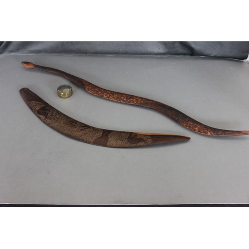 249 - An Australian carved hardwood boomerang, 70cm wide, a further boomerang in shape of snake, 98cm wide... 