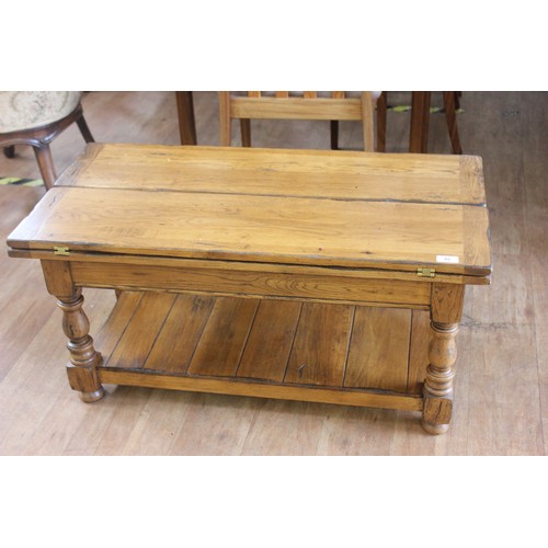 82 - An elm and pine refectory style coffee table, with hinged flaps, 91cm long.