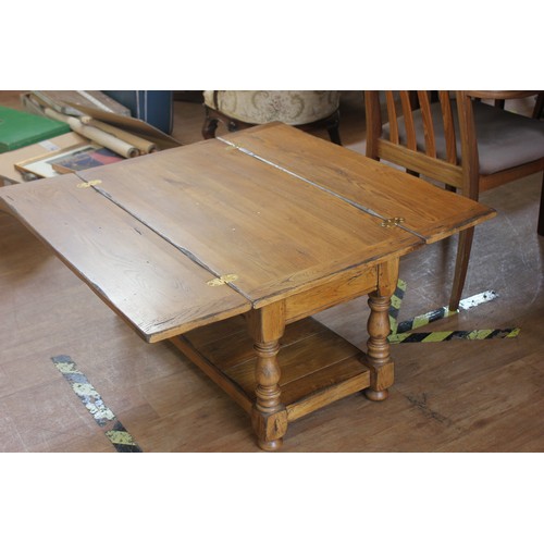 82 - An elm and pine refectory style coffee table, with hinged flaps, 91cm long.