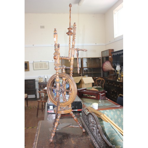 83 - A stained beech Victorian style spinning wheel, on tripod base, 113cm high.