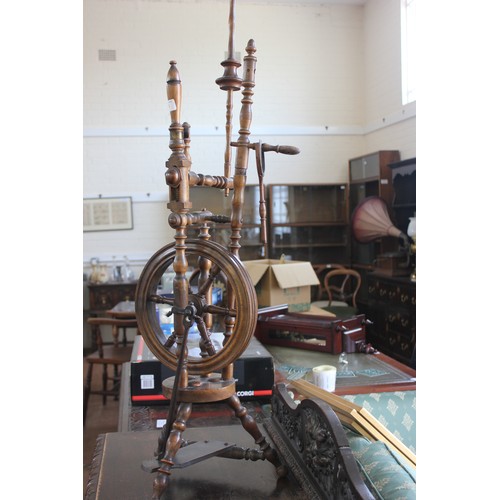 83 - A stained beech Victorian style spinning wheel, on tripod base, 113cm high.