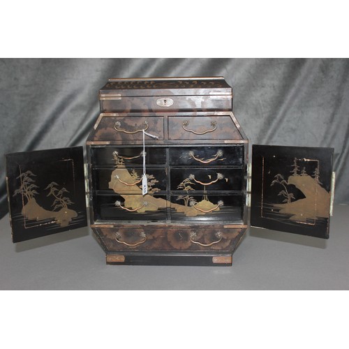 216 - An early 20th century Japanese lacquered table cabinet,  with hinged lid, above two drawers, further... 