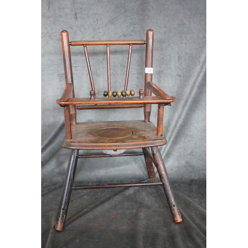 129 - An early 20th century stained beech child's commode/training chair, on turned tapering legs, united ... 