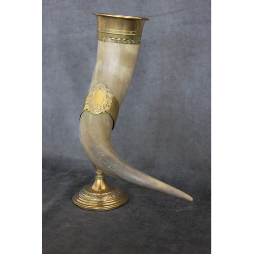 135 - A horn libation cup, with gilt brass mount, fitted to gilt brass decorative holder and stand, on cir... 