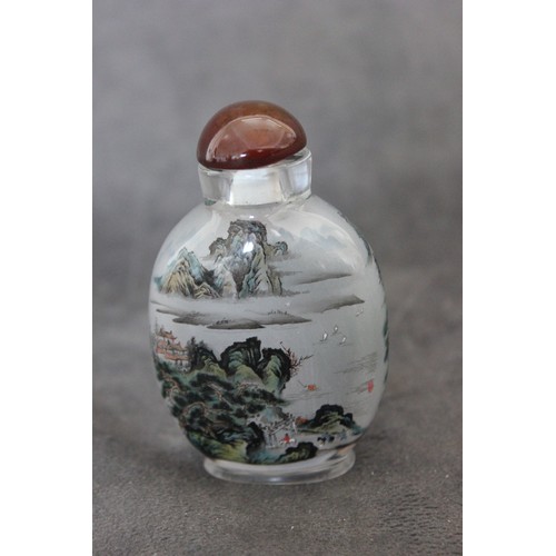 143 - A 20th century Chinese interior decorated glass scent bottle, with agate stopper, 8cm high.