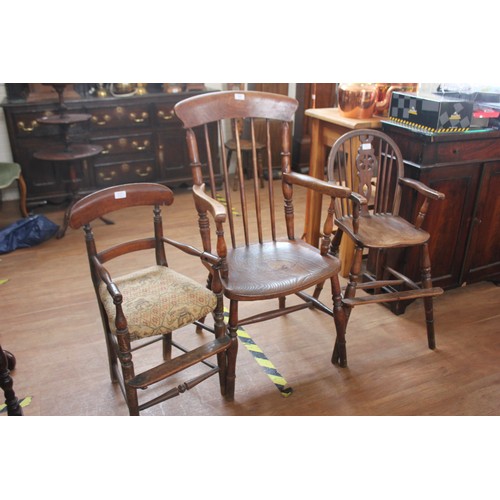 145 - An elm and stained beech kitchen Windsor elbow chair, on turned legs united by stretchers, together ... 