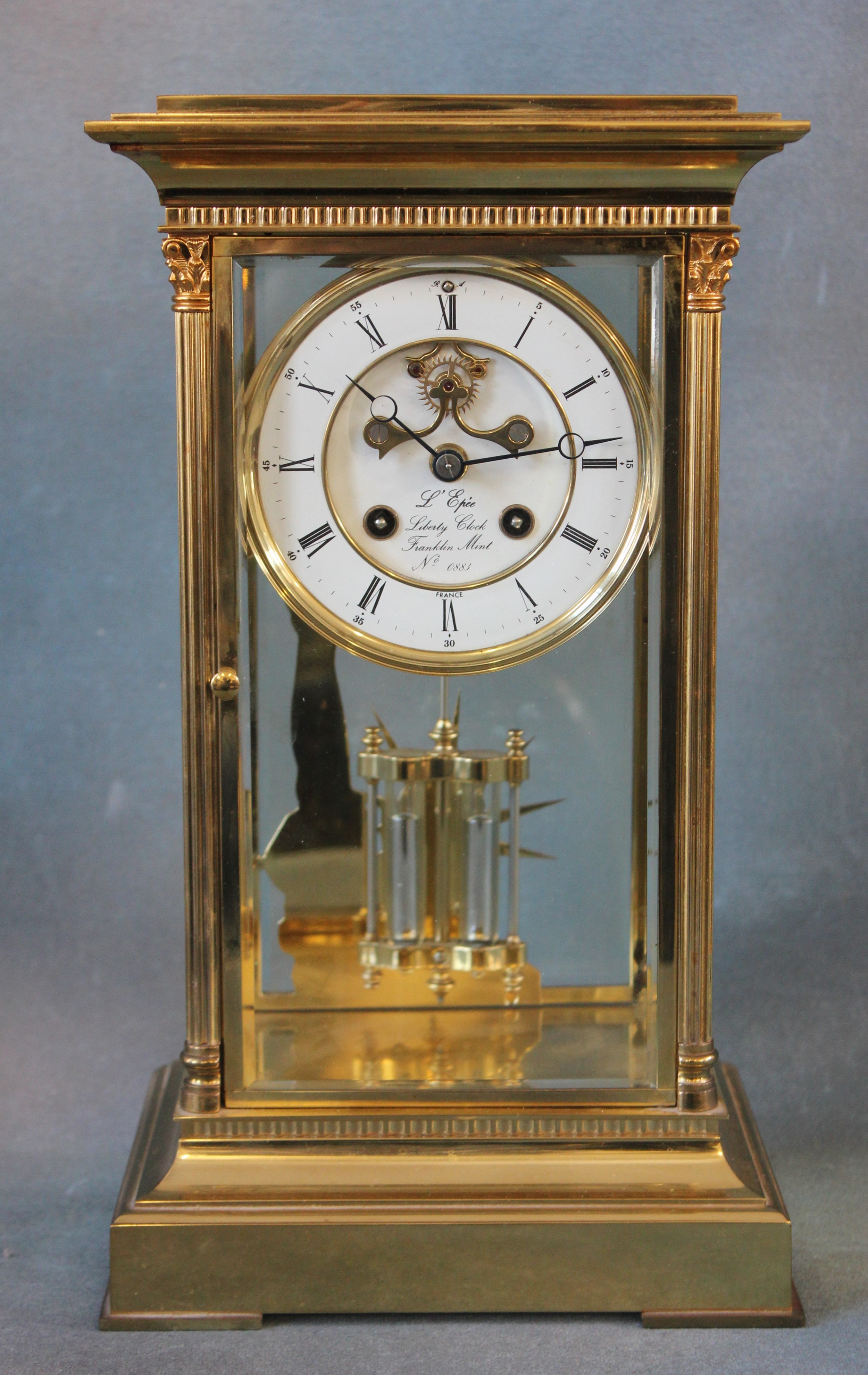 A limited edition gilt brass four glass liberty clock, with white