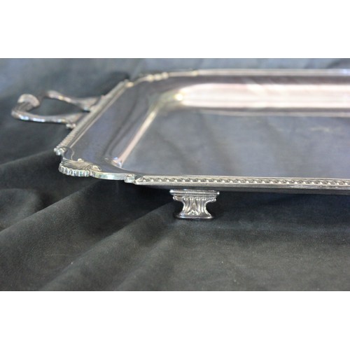 14 - A silver-plated two-handled tray, with gadrooned and shell decoration, 70cm wide.