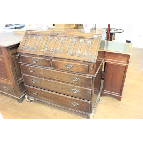 177 - A reproduction oak bureau, with linen fold panel fall, above two short and three long drawers, 96cm ... 