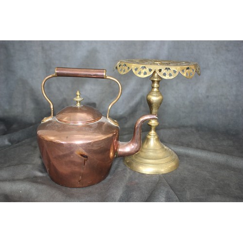 248 - A circular brass trivet, 25cm high, and a copper kettle (2).