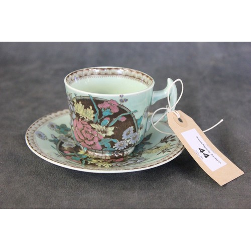 269 - A Clarice Cliff Newport pottery cup and saucer, decorated peonies and lotus blossom, on pale green g... 