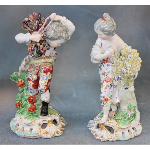 107 - A pair of Derby figures of boy and girl, emblematic of winter and summer, c. 1770, on gilded scroll ... 