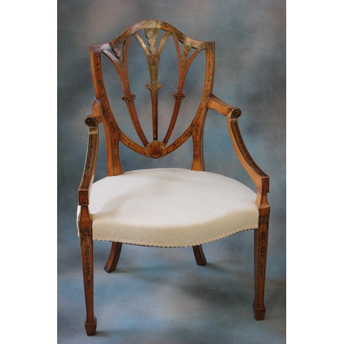 129 - A late 19th century Sheraton revival style painted satinwood shield back elbow chair, on square tape... 