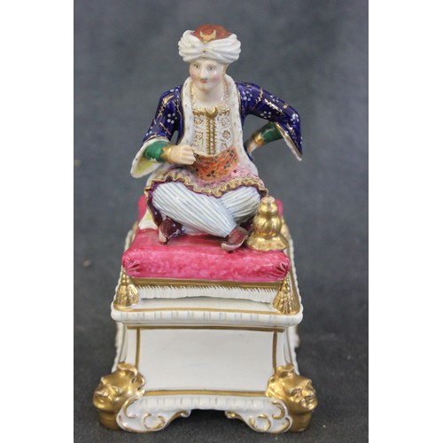 71 - A Derby figure of a seated Turk, c. 1825-30, imitation crossed swords mark to base, 15cm high, ex Ph... 