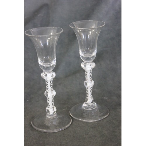 79 - A pair of 18th century Dutch wine glasses, with opaque twist stems and bell bowls, c. 1765, each 16.... 