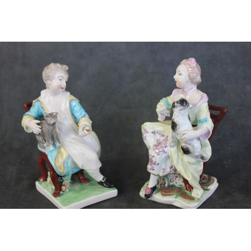 111 - A pair of Derby figures of seated children, holding a dog and a cat, on square patch marked bases, e... 