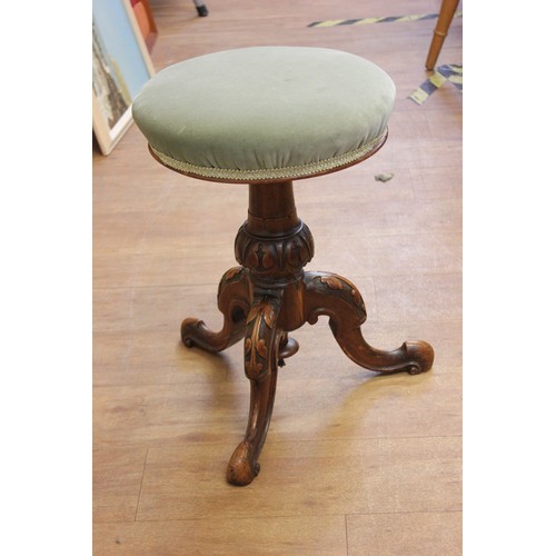 119 - A Victorian piano stool, with circular pad seat, adjustable for height, on carved walnut tripod base... 