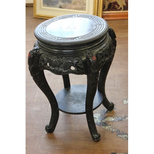 126 - A Chinese carved and ebonised wood urn stand, on four shaped legs, united by an undertier, 60cm high... 