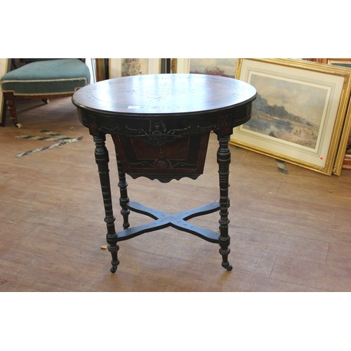 127 - A Victorian ebonised and amboyna oval shaped worktable, on four turned and ringed legs united by cro... 