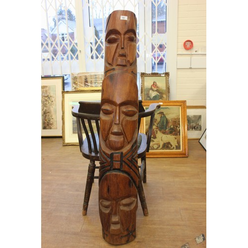 182 - A small carved wood totem type pole, with three masks, 20cm wide x 134cm high.