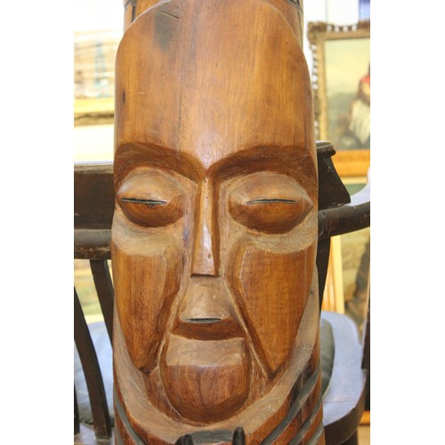 182 - A small carved wood totem type pole, with three masks, 20cm wide x 134cm high.