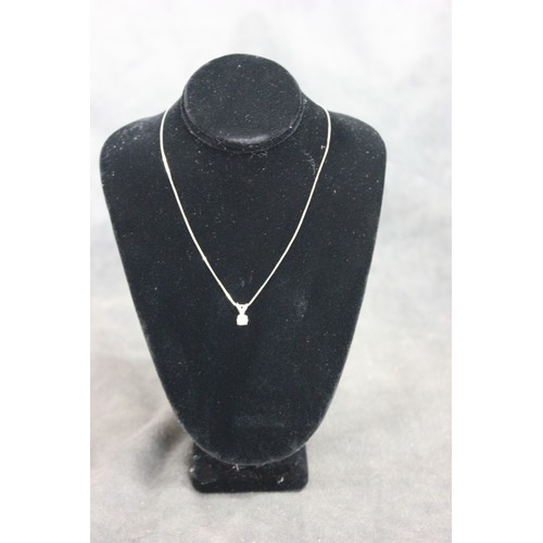 190 - A 14k white metal diamond pendant, on slender link chain, set a single stone.