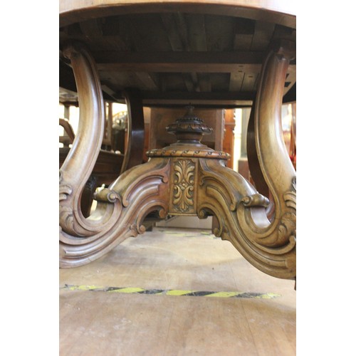 251 - A late Victorian/early 20th century mahogany oval form dining table, with wind out action and moulde... 