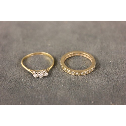 298 - A gold three stone diamond set dress ring, and a 9ct gold set eternity ring, approx. 41g, weighable ... 