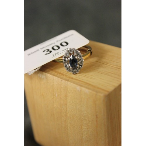 300 - A 9ct gold dress ring, set an oval sapphire and ten diamonds of small size.