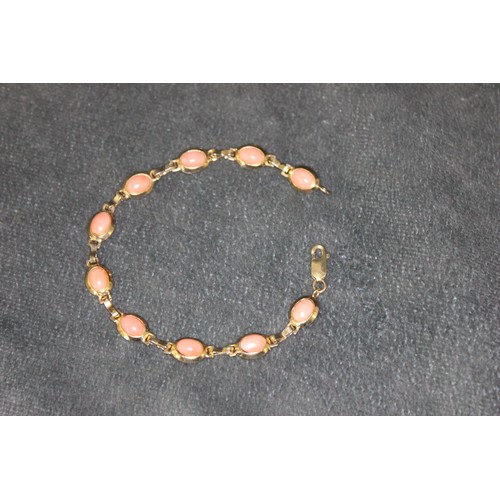 331 - A 9ct gold bracelet, set ten simulated coral beads, 19cm long.