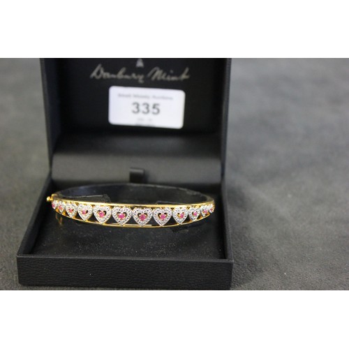 335 - A gilt metal stone set love bangle, in Danbury Mint box.