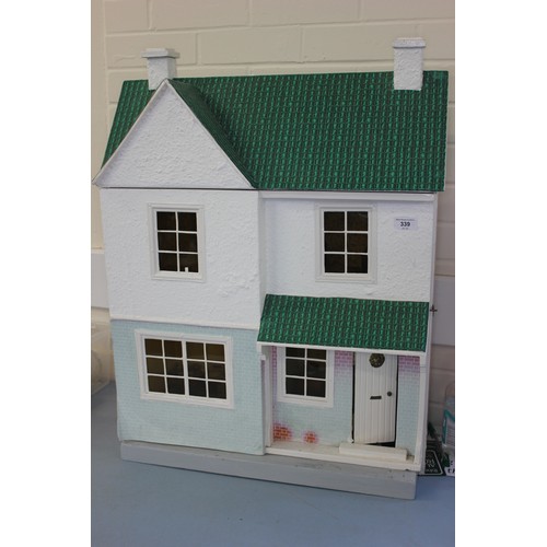 339 - A scale model dolls house, with contents, 54cm wide x 76cm high.