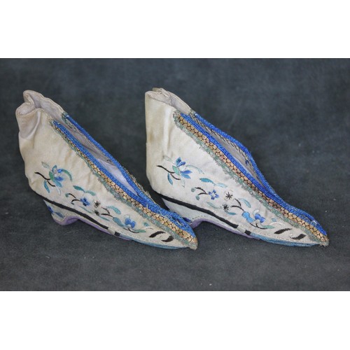 343 - A pair of 19th century Chinese embroidered silk shoes, each 14cm long.