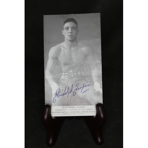 187 - A black and white photographic postcard of Randolf Turpin, the Middleweight World Champion boxer, wh... 