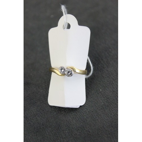 206 - An 18ct gold two stone diamond cross-over style dress ring, collet set, size M.