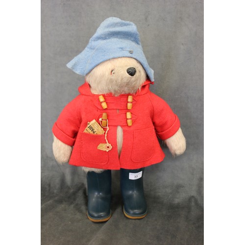 235 - A Paddington Bear, by Gabrielle Designs Ltd, in red coat, dark blue wellingtons and pale blue hat, t... 