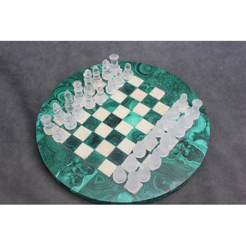 5 - A circular malachite and alabaster chess board, 24cm in diameter, and a frosted and clear glass ches... 