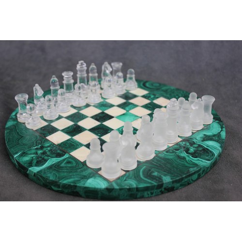 5 - A circular malachite and alabaster chess board, 24cm in diameter, and a frosted and clear glass ches... 