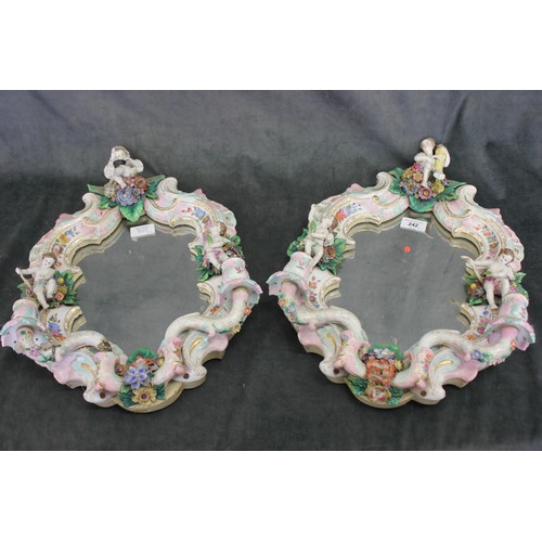 242 - A pair of 19th century Dresden porcelain girandole wall mirrors, with decoration of putti, each 32cm... 