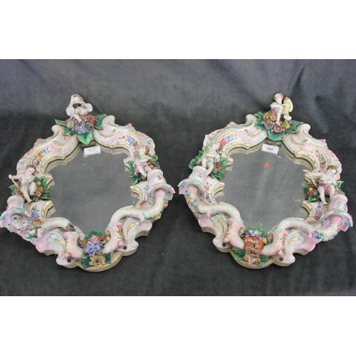 242 - A pair of 19th century Dresden porcelain girandole wall mirrors, with decoration of putti, each 32cm... 