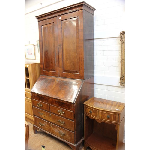 237 - An 18th century walnut veneered bureau cabinet, the upper part enclosed by panelled doors, the slopi... 