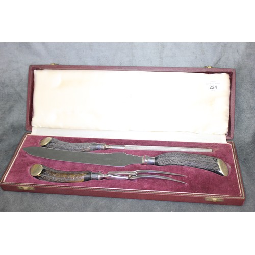 224 - A three piece horn handled carving set, with silver-plated ferrules and terminals, in lined Asprey a... 