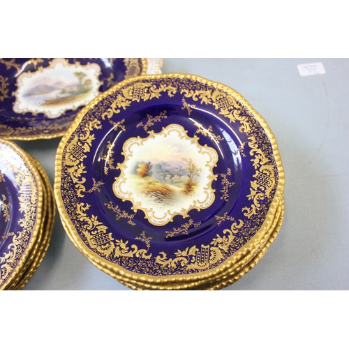 221 - A Coalport part fruit/dessert set, blue and gilt, with painted central panels, comprising:- 