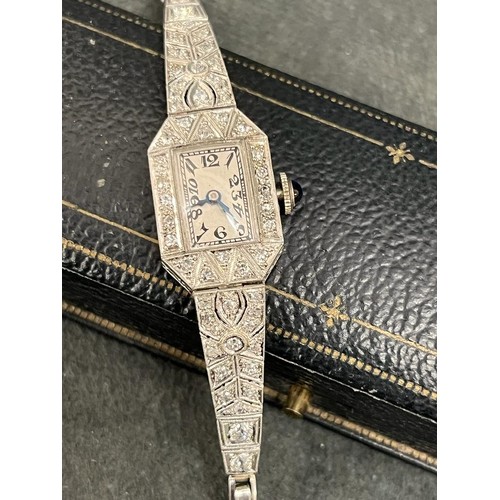 215 - A lady's platinum cocktail wristwatch, in octagonal shaped case, set fifty-four graduated diamonds, ... 