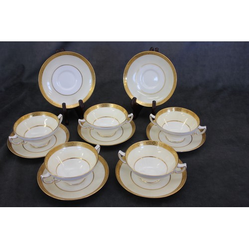 29 - A set of five Mintons cream and gilt two handled soup cups and saucers, made for 