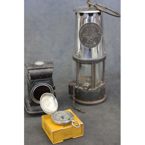 34 - A Dennison First World War compass, in a watch case box, a Miner's safety lamp, by 