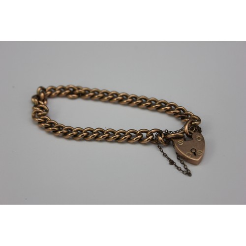 61 - A metal curb link bracelet with padlock, 18cm long, unmarked.